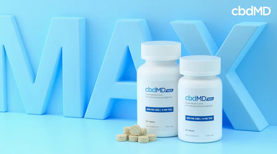 Two max for pain 200 mg cbd 4 mg thc next to each other with multiple tablets laying next to them with the word max behind it - cbdMD