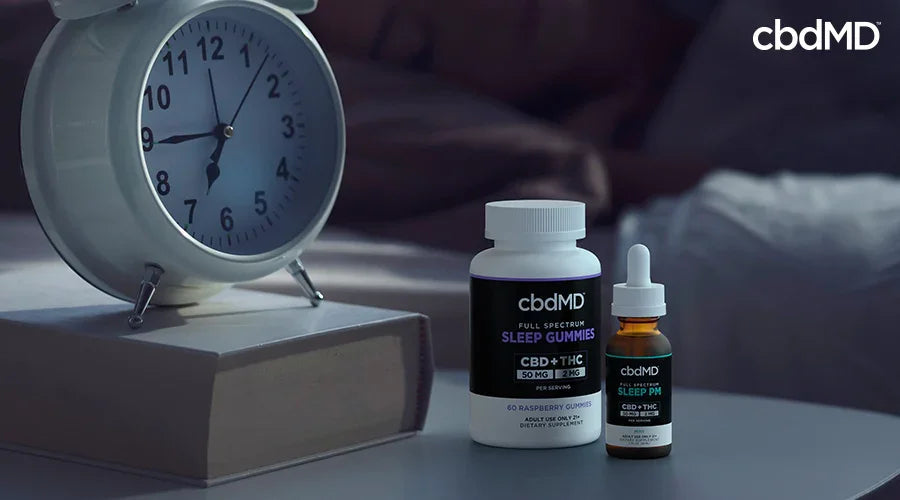 CBD sleep gummies and oil on a bedside table with alarm clock and book, promoting sleep support