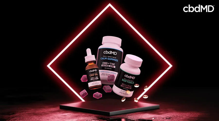 Full spectrum CBD oil, gummies, and softgels with capsules and gummies on black background