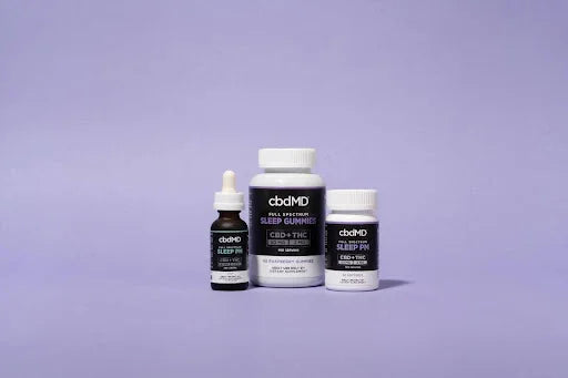 CBD sleep gummies, oil dropper, and capsules on a purple background