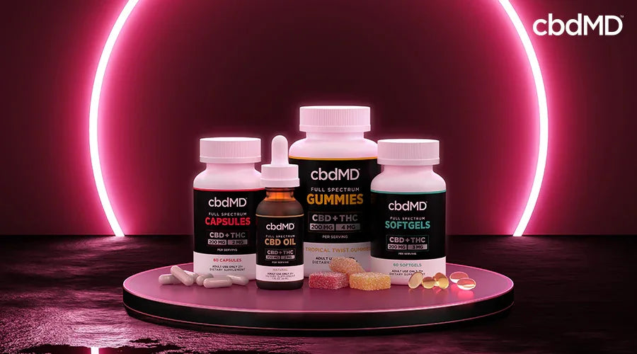 Full spectrum CBD oil, capsules, gummies, and softgels displayed on a pink neon-lit pedestal.