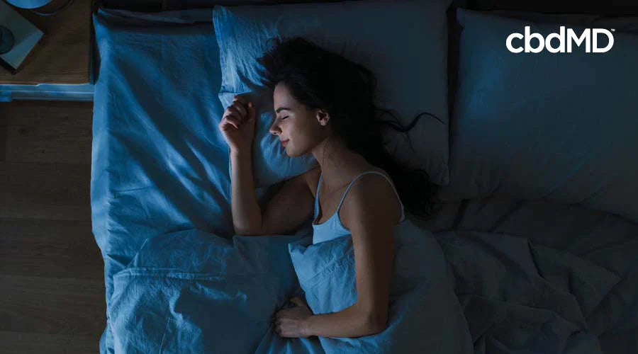 Woman peacefully sleeping in bed at night, promoting natural sleep support