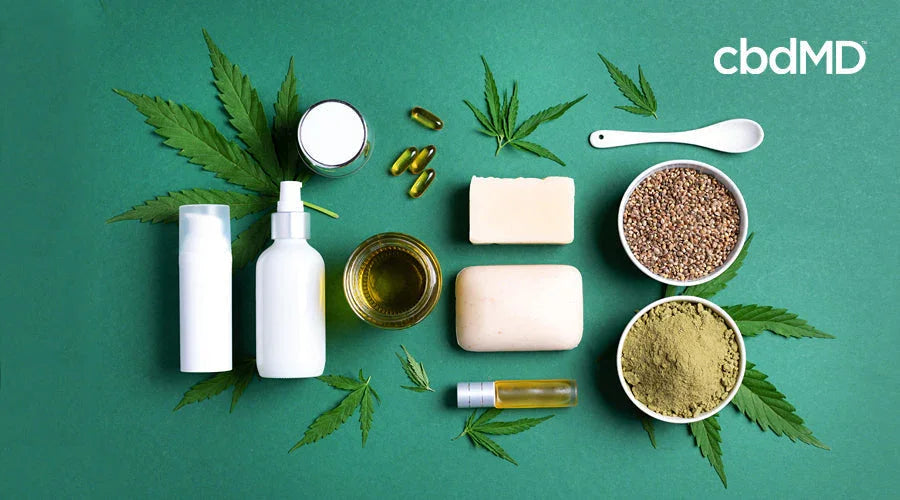 birdseye view of hemp powder, oil and cream laying on a green counter top