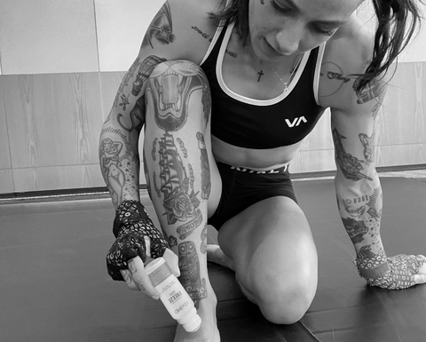 athlete Jessica Rose Clark using a cbd topical on her foot