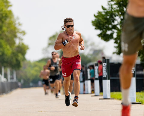 athlete justin medeiros in red shorts runnning outside